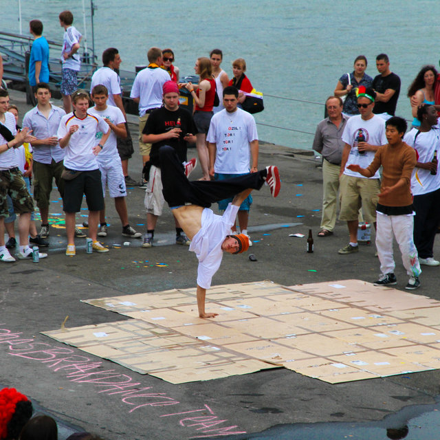 Breakdancers performing near the Rhine.
