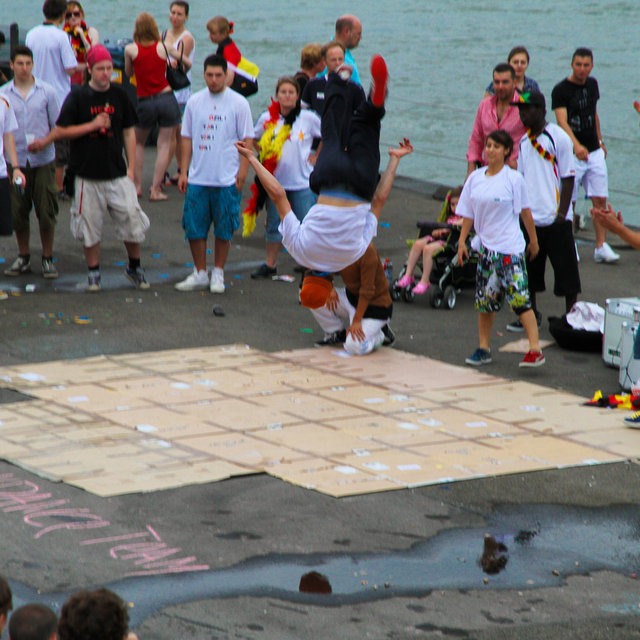 Breakdancers performing near the Rhine.