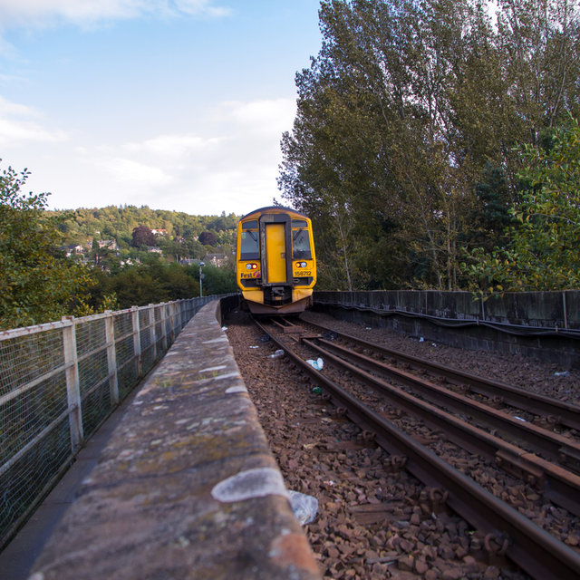 Local train passing on the pedestrian and train bridge over the River Tay.