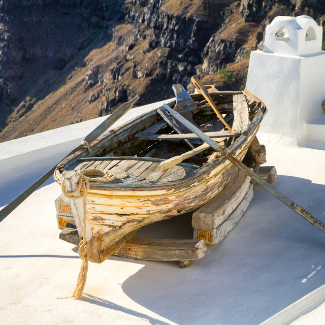 Old rowboat situated on a rooftop terrace in Firá.
